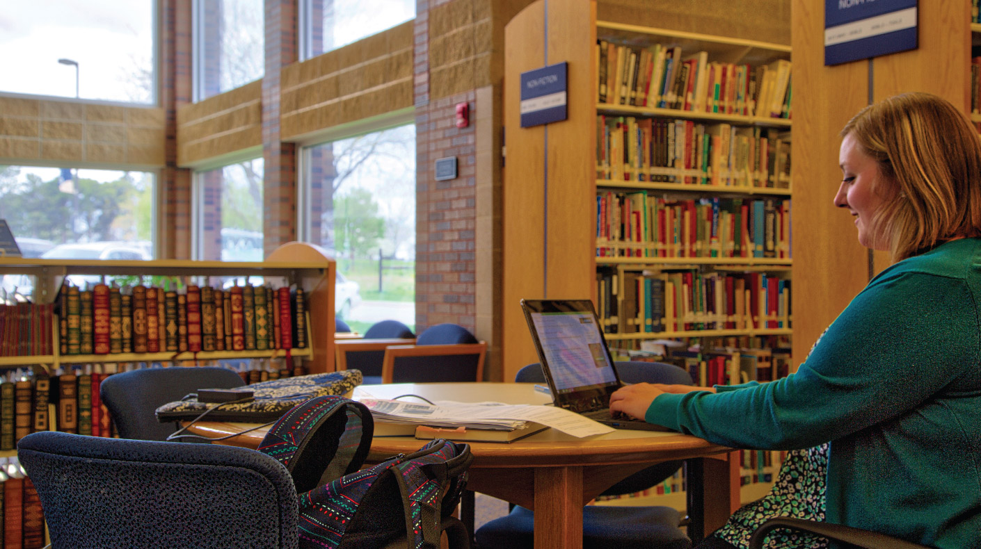 Mount Marty Student in Library