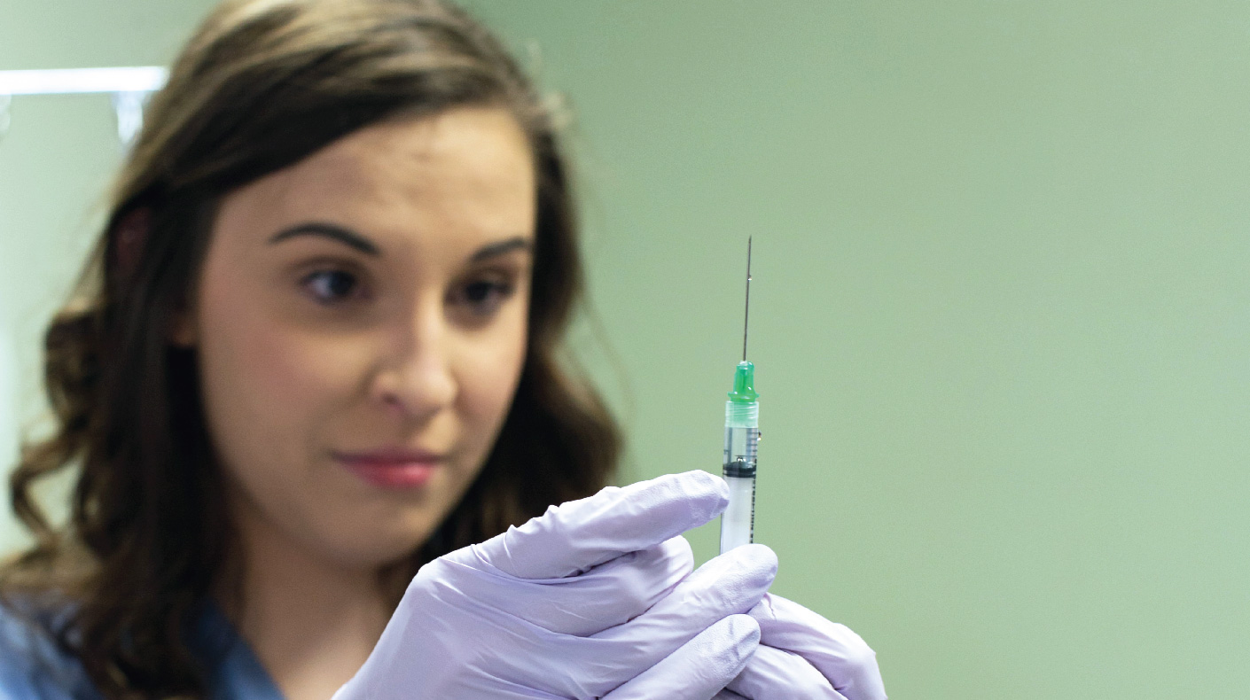 Nursing Student Preparing to Administer Shot for Practice